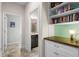 Hallway view of full bathroom with granite counters and decorative shelving at 1631 Nina Dr, Davenport, FL 33837