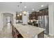 Well-equipped kitchen with granite countertops, stainless steel appliances, and a large center island with seating at 1631 Nina Dr, Davenport, FL 33837