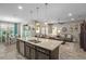 Open-concept kitchen with a spacious island that overlooks the living room and dining area at 1631 Nina Dr, Davenport, FL 33837