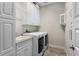 Functional laundry room includes a washer, dryer, sink, and storage cabinets at 1631 Nina Dr, Davenport, FL 33837