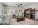 Cozy living room with ceiling fan, comfortable furniture, and large entertainment center with built-in shelving at 1631 Nina Dr, Davenport, FL 33837