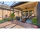 Inviting screened lanai with comfortable seating, ceiling fan, and a view of the beautifully landscaped backyard at 1631 Nina Dr, Davenport, FL 33837