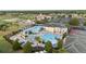 A stunning aerial view of the community pool featuring a slide, ample seating and sunbathing areas, as well as mature landscaping at 1631 Nina Dr, Davenport, FL 33837