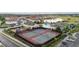 An aerial view showcases the community tennis courts next to a pool and playground at 1631 Nina Dr, Davenport, FL 33837