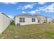 Spacious backyard, enclosed by a fence, with a covered patio area at 1828 Buckeye Rd, Davenport, FL 33837