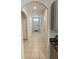 Hallway with neutral tile flooring, multiple doors, and access to other parts of the home at 1828 Buckeye Rd, Davenport, FL 33837