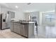 Well-designed kitchen featuring stainless steel appliances, granite countertops, a central island with seating, and an adjacent dining area at 1828 Buckeye Rd, Davenport, FL 33837