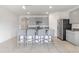 Open kitchen with granite countertops, stainless steel appliances, gray cabinets, and a central island offering both style and functionality at 1828 Buckeye Rd, Davenport, FL 33837