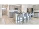 This kitchen features granite countertops, stainless steel appliances, a breakfast bar, and a well-lit dining area with tile flooring at 1828 Buckeye Rd, Davenport, FL 33837