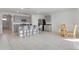 The open-concept kitchen seamlessly flows into the dining area and living space with granite countertops, stainless steel, and modern cabinets at 1828 Buckeye Rd, Davenport, FL 33837