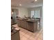 Kitchen with granite island, stainless steel appliances, grey cabinets and tile floor at 1828 Buckeye Rd, Davenport, FL 33837