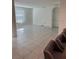 Open-concept living room with tile floors, ample natural light and a view of the kitchen at 1828 Buckeye Rd, Davenport, FL 33837