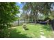 A relaxing backyard with a fountain, water view, hammock, and mature trees at 202 Acadia Ter, Kissimmee, FL 34747