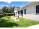 Landscaped backyard featuring a lush lawn, charming garden, stone path, and well-manicured greenery at 202 Acadia Ter, Kissimmee, FL 34747
