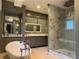 Bright bathroom featuring a walk-in shower, freestanding tub, and vanity with vessel sink and decorative mirror at 202 Acadia Ter, Kissimmee, FL 34747