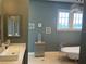 Bright bathroom with freestanding tub, statement chandelier, and vanity with vessel sink and decorative mirror at 202 Acadia Ter, Kissimmee, FL 34747