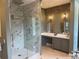 Bathroom features a luxurious walk-in shower with marble-style walls and a separate vanity area at 202 Acadia Ter, Kissimmee, FL 34747