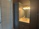 Bathroom featuring gray cabinets, quartz countertops, and ample storage at 202 Acadia Ter, Kissimmee, FL 34747