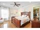 Cozy bedroom with hardwood floors, ceiling fan, and a walk-in closet with ample storage at 202 Acadia Ter, Kissimmee, FL 34747