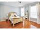 Inviting bedroom with hardwood floors, natural light, and neutral tones for a comfortable atmosphere at 202 Acadia Ter, Kissimmee, FL 34747