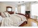 Comfortable bedroom with hardwood floors, ceiling fan, and TV, offering a welcoming retreat at 202 Acadia Ter, Kissimmee, FL 34747