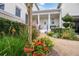 Charming entrance with a column-lined porch, beautiful landscaping, and a welcoming white front door at 202 Acadia Ter, Kissimmee, FL 34747