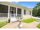 Charming front porch with white columns, sundial, and mature landscaping at 202 Acadia Ter, Kissimmee, FL 34747