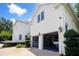 Spacious garage with open doors revealing a multi-car garage with beautiful landscaping at 202 Acadia Ter, Kissimmee, FL 34747
