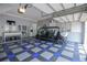Well-organized garage with a multi-seat electric vehicle, custom flooring, and ample storage space at 202 Acadia Ter, Kissimmee, FL 34747