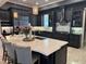 Contemporary kitchen featuring dark cabinets, stainless appliances, and a large island at 202 Acadia Ter, Kissimmee, FL 34747