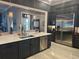 Spacious kitchen with a large island, stainless steel appliances, and dark wood cabinets at 202 Acadia Ter, Kissimmee, FL 34747