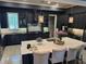 Modern kitchen with a marble island, stainless steel appliances, and black cabinetry at 202 Acadia Ter, Kissimmee, FL 34747