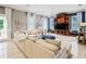 Living room with built-in shelving, light furniture, hardwood flooring and many windows at 202 Acadia Ter, Kissimmee, FL 34747