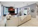 Bright living room with a large beige sectional sofa, custom built-ins, and a chandelier at 202 Acadia Ter, Kissimmee, FL 34747