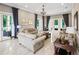 Bright living room with tiled floors, neutral paint, elegant furnishings and french doors at 202 Acadia Ter, Kissimmee, FL 34747