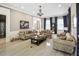 Spacious living room with coffered ceiling, tiled floors, and three sofas with neutral paint at 202 Acadia Ter, Kissimmee, FL 34747