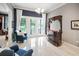 Sitting area with natural light and french doors that lead to the outdoors and dark wood bar at 202 Acadia Ter, Kissimmee, FL 34747