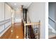 Staircase features wood railing with iron spindles, hardwood floors, and white wainscoting at 202 Acadia Ter, Kissimmee, FL 34747