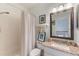 Bright bathroom with a shower-tub combination, featuring modern fixtures and a clean, inviting aesthetic at 206 Norfolk Pl, Celebration, FL 34747