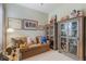 Cozy bedroom showcasing decorative shelving, couch, and various decorative elements at 206 Norfolk Pl, Celebration, FL 34747