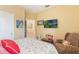 Comfortable bedroom features a cozy chair, adding charm and character to the inviting space at 206 Norfolk Pl, Celebration, FL 34747