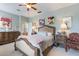 Comfortable bedroom with a beautiful bed, stylish decor, and great light creating a cozy and inviting space at 206 Norfolk Pl, Celebration, FL 34747