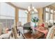 Bright dining room featuring a chandelier, miniature piano, and charming decorative accents at 206 Norfolk Pl, Celebration, FL 34747