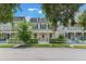 Attractive two-story yellow home with a cozy front porch and charming white picket fence at 206 Norfolk Pl, Celebration, FL 34747