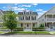 Charming two-story yellow home with a welcoming front porch and white picket fence at 206 Norfolk Pl, Celebration, FL 34747