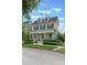 Charming two-story yellow home with a welcoming front porch and white picket fence at 206 Norfolk Pl, Celebration, FL 34747