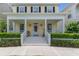Inviting front porch with white columns, decorative wreath, and well-maintained landscaping at 206 Norfolk Pl, Celebration, FL 34747