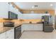 Updated kitchen featuring white cabinetry, granite countertops, stainless steel appliances, and ample storage at 206 Norfolk Pl, Celebration, FL 34747