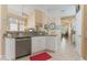 Modern kitchen with granite countertops, stainless steel dishwasher, and an open view into the Gathering room at 206 Norfolk Pl, Celebration, FL 34747