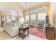 Bright living room featuring high ceilings, large windows, and comfortable neutral furniture at 206 Norfolk Pl, Celebration, FL 34747